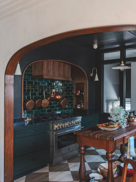 Arched entry view of a kitchen with green tiles and wood accents in Park Hill, Denver.