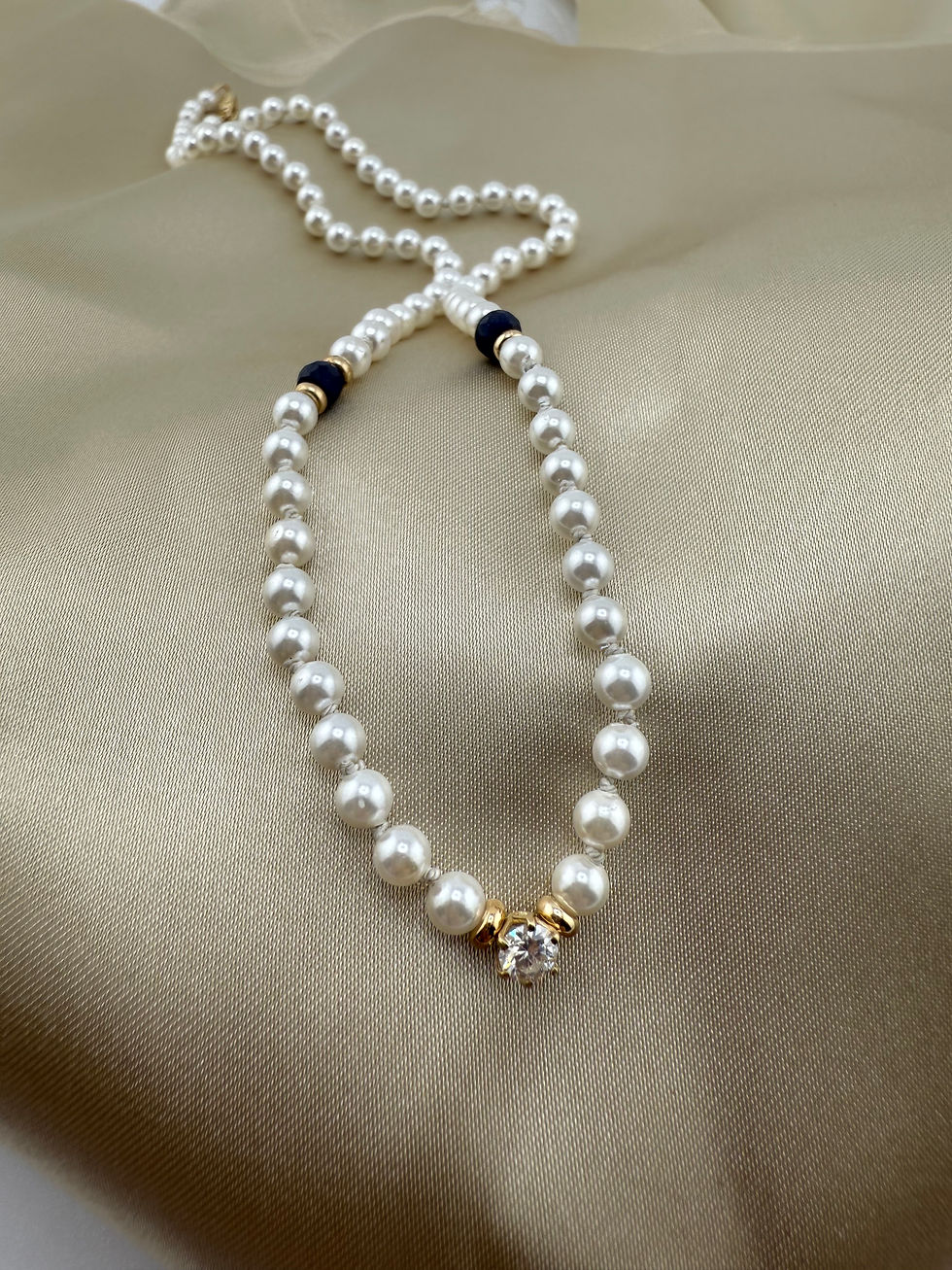 knotted pearl necklace with emerald and diamond