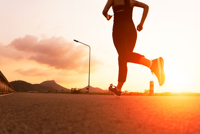 sport-woman-running-road-fitness-woman-training-sunset.jpeg
