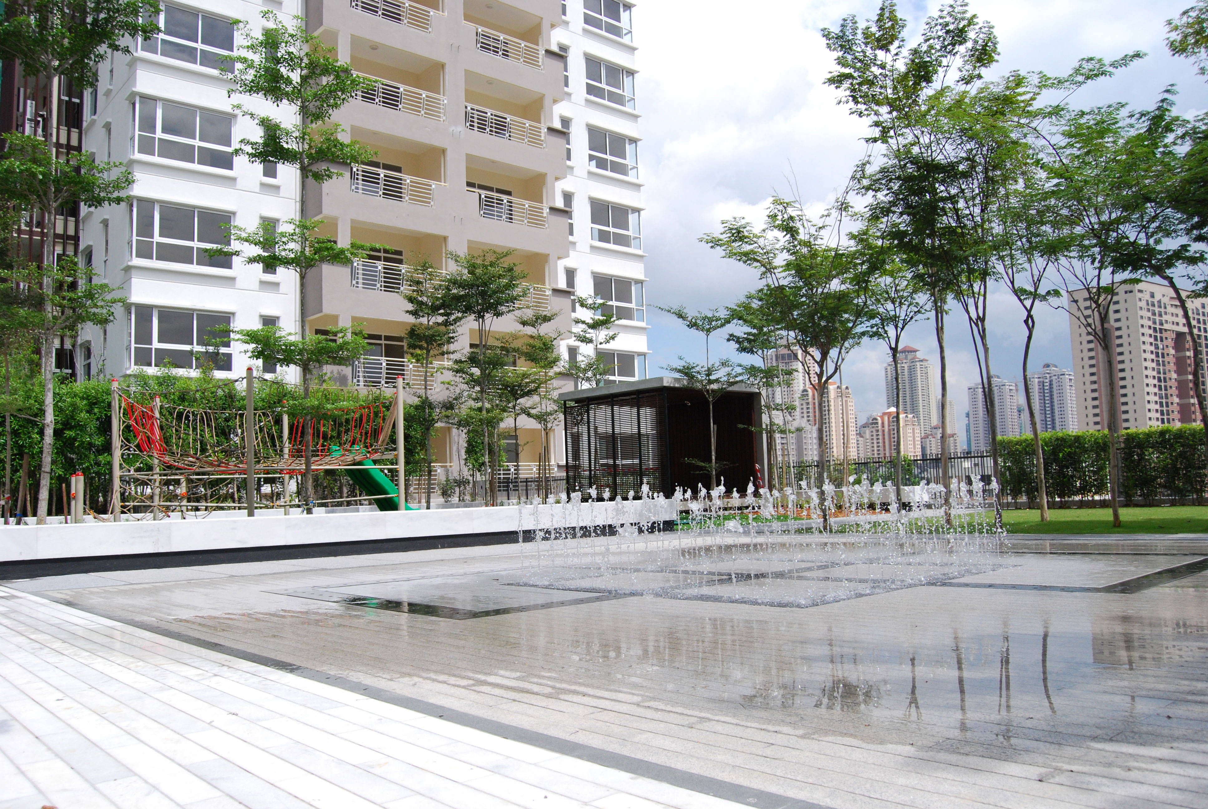 Hijauan Kiara: the children's playground and splash fountain, with a tower behind