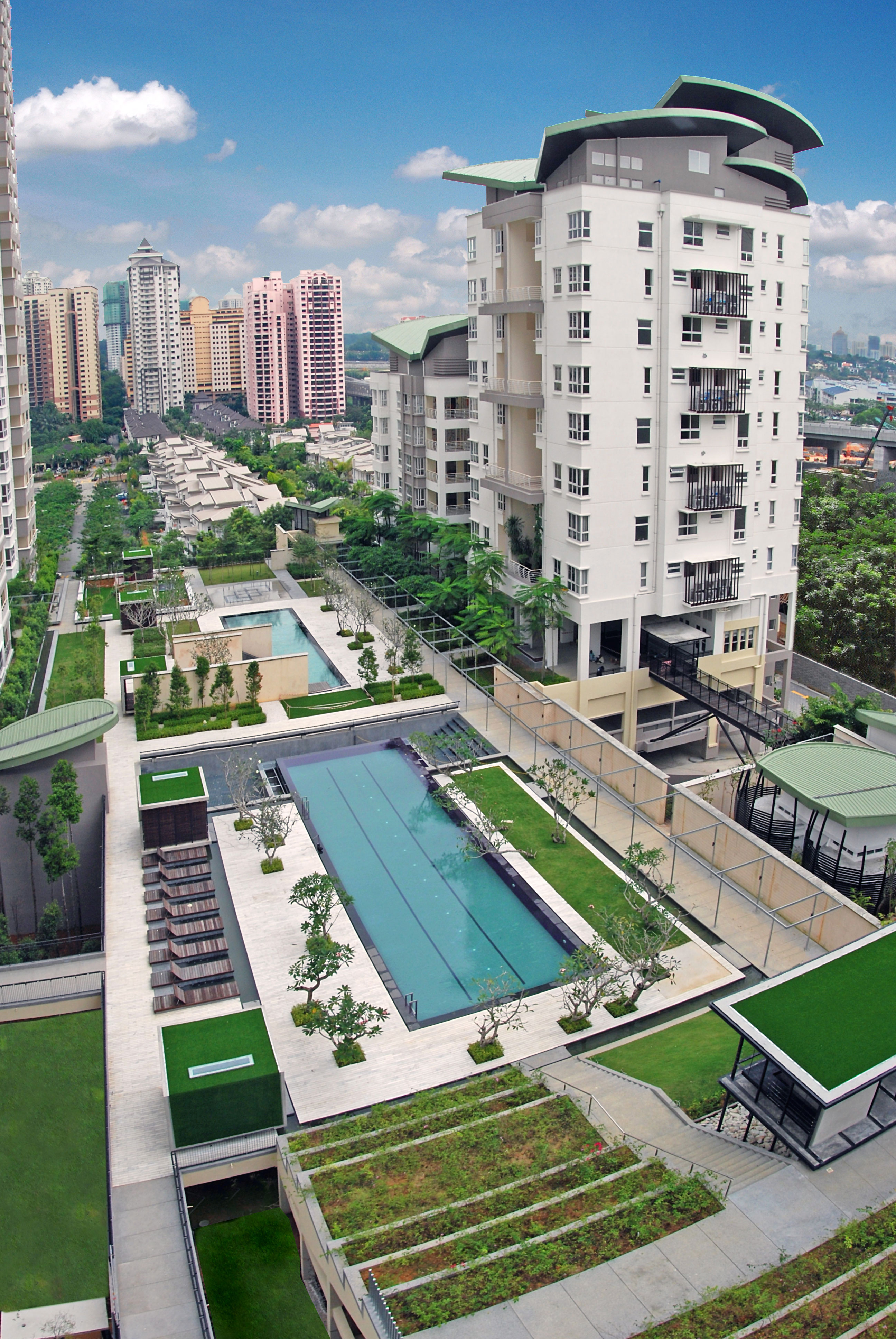 Hijauan Kiara: an aerial view of the towers and pool decks, with the city beyond