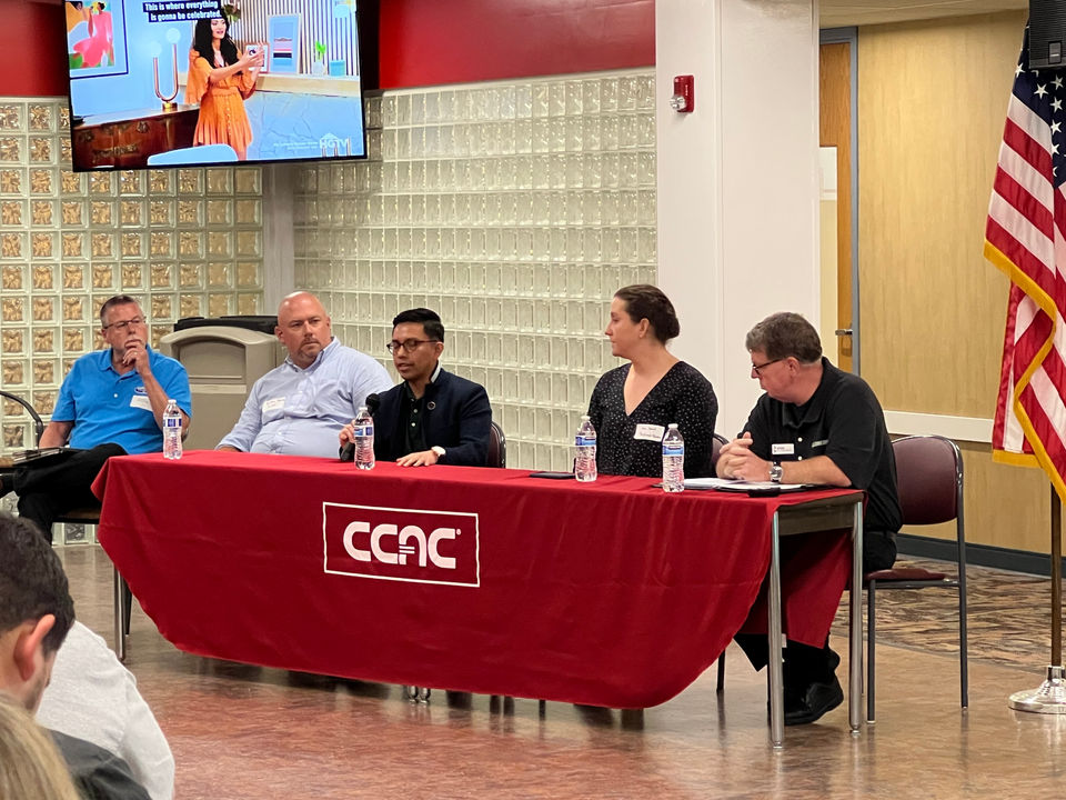 A group of five alternative fuel vehicle experts assembled around a CCAC table to deliver a panel session presentation at Odyssey Day.