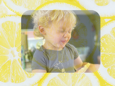 a child sucking a lemon