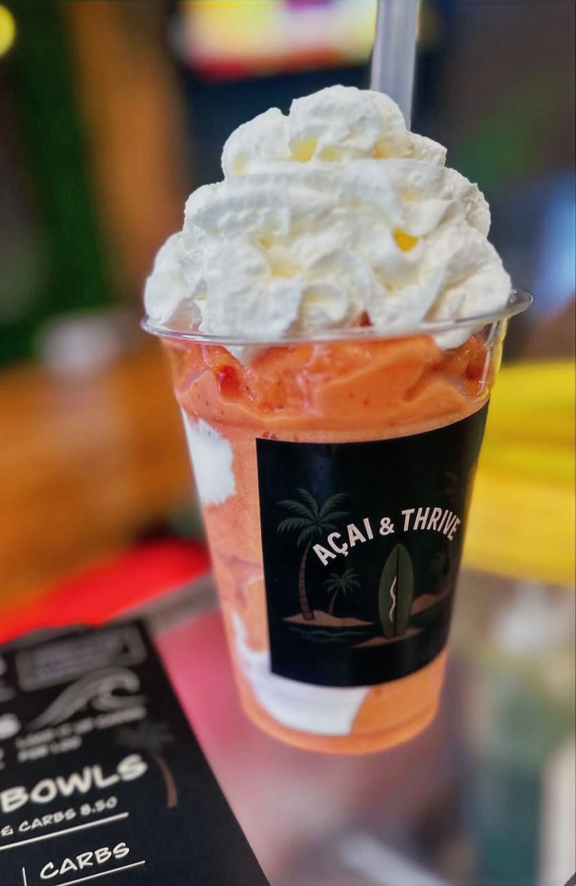 Pink and white healthy smoothie from acai and thrive cafe