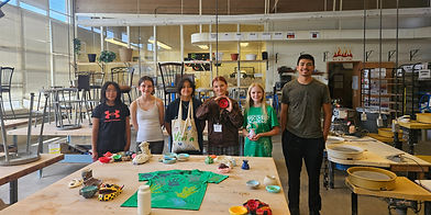 students with their ceramic works