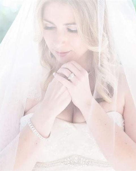 Bridal hair & makeup by Make-up N More featuring soft glam and elegant veil over face with soft glam waves