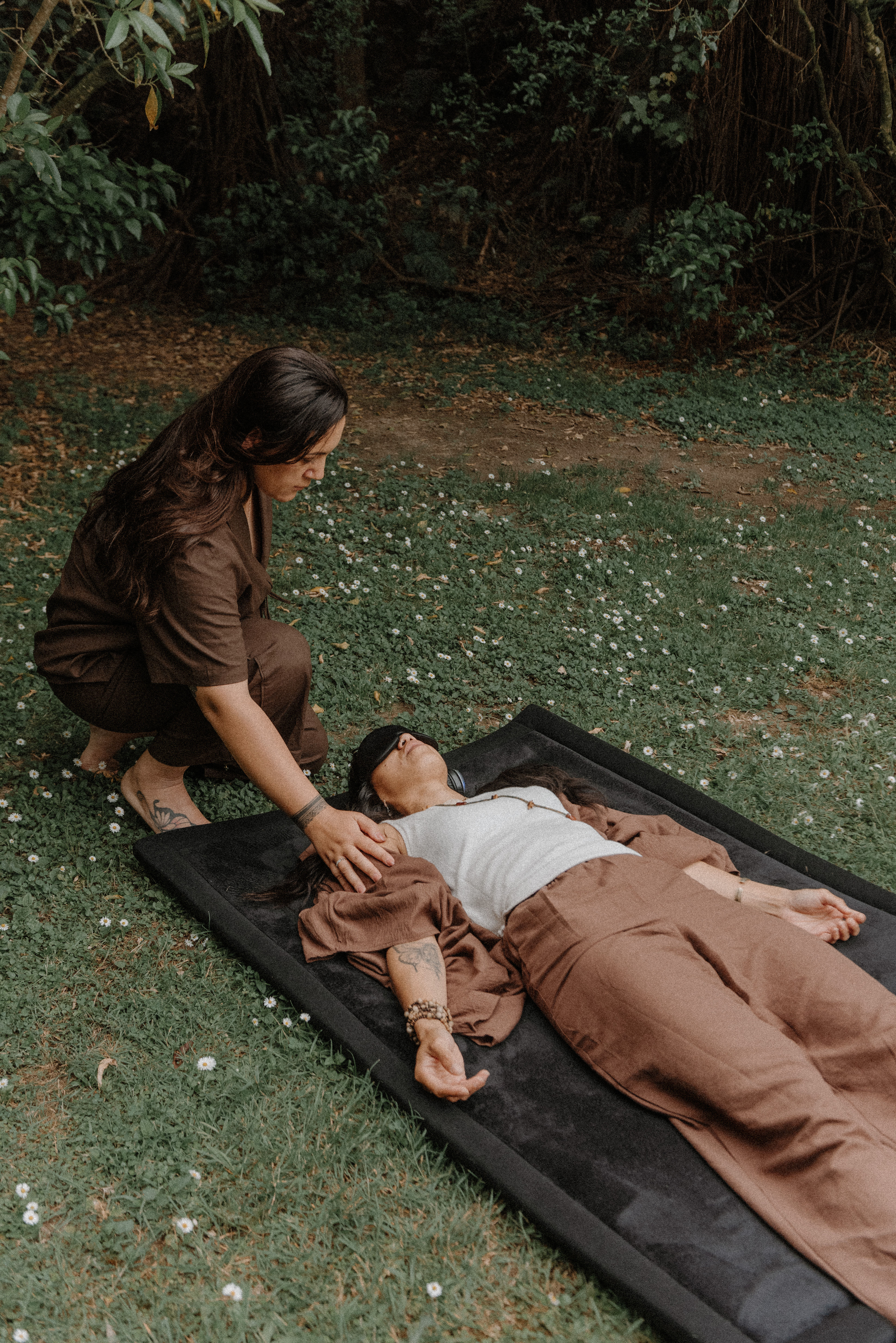 woman lying on earth during 9d breathwork trauma release session