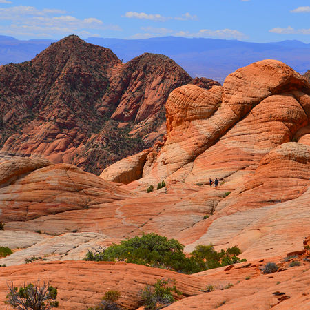Striped sandstone cliffs overlooking distant mountains at Yant Flat Candy Cliffs Southern Utah