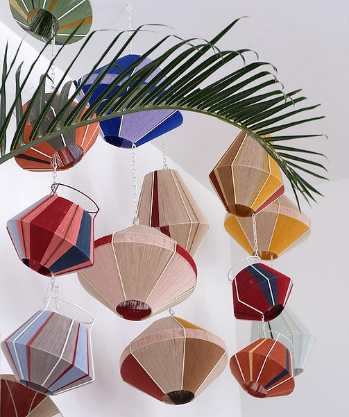 Colourful handmade lamps displayed together showcasing bespoke design and vibrant hues, perfect for enhancing any interior.