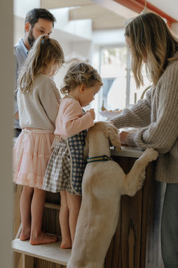 A family spending a quiet Sunday morning together in their kitchen during a natural, lifestyle family photoshoot in Peckham, South East London