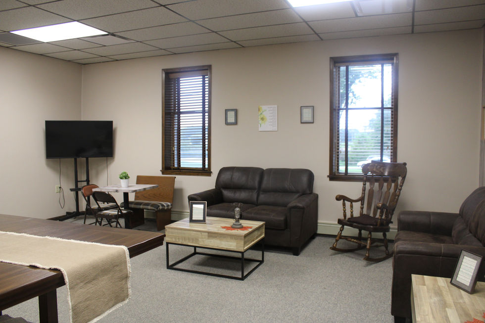 Cozy room with sofa, rocking chair, and TV