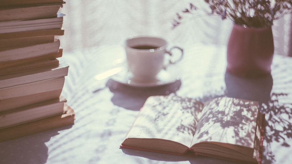 open book beside white ceramic teacup on saucer_edited.jpg
