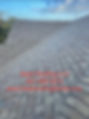 The image depicts a close-up view of a shingle roof with a woven valley design. The roof is covered with rectangular shingles with a dark, textured appearance. The woven valley technique involves interweaving shingles from both sides of the valley, creating a pattern that resembles a woven basket. The valley is covered with a strip of metal flashing, which is visible in the center of the image. The flashing is designed to prevent water from seeping under the shingles and causing damage to the roof structure. The woven valley technique is a popular alternative to the open and closed valley designs, as it provides an attractive and distinctive appearance while maintaining the functionality of the valley.