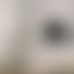 Serene living room with a laptop on a white sofa and a styled coffee table representing the importance of purposeful layout decisions, like avoiding social media icons in your website header.