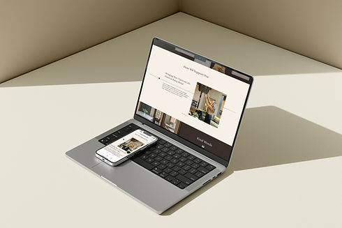 Laptop with a phone resting on top, both displaying the services section of Kalissa Wilson Interiors, a custom interior design website designed by Cathleen Hall Creative.