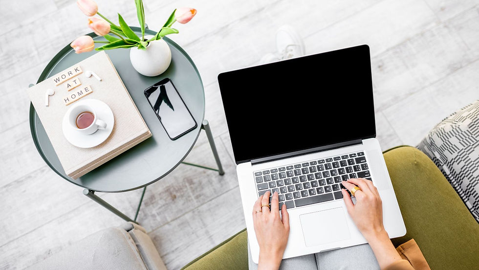 Web designer for interior designers typing on computer sitting in office.