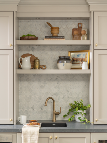 Wet bar with custom built-in cabinets, sink, microwave, and wine fridge designed by Design Studio Detroit for a luxury residential project.