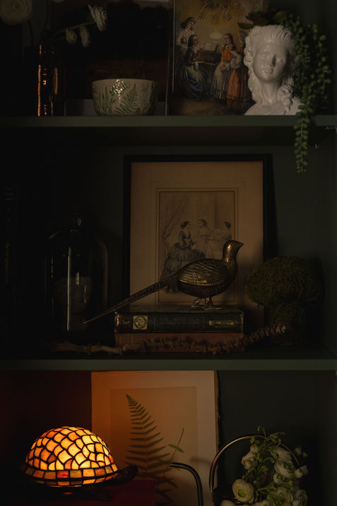 Custom shelving filled with books, statues, and framed artwork, styled to showcase personality, cherished pieces, and collected treasures.