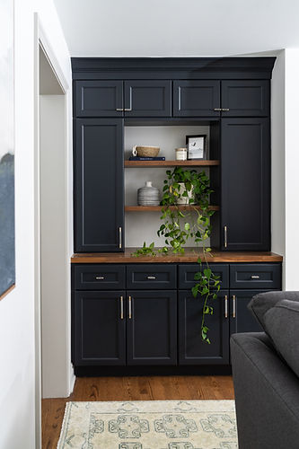 Custom dark blue cabinetry with wood shelving and styled décor created by Design Studio Detroit for builder and remodeler collaborations.