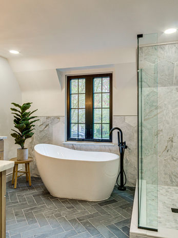 Luxury bathroom featuring a large granite walk-in shower and spacious vanity designed for a full-service home renovation in Michigan.
