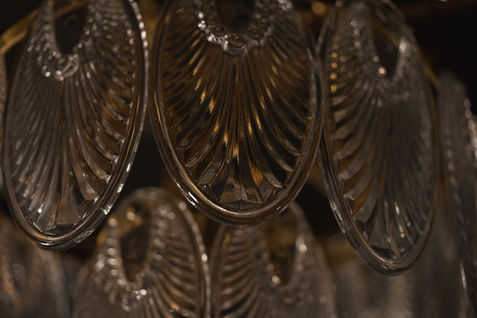 Detail of glass lamp showcasing texture and layered styling.