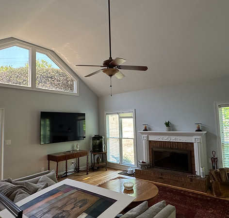 Before image of Project Clarks the living room angled at fireplace.