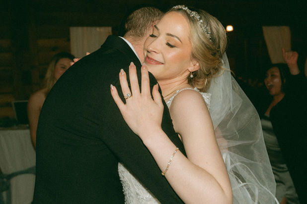 Bride and groom embracing at wedding reception