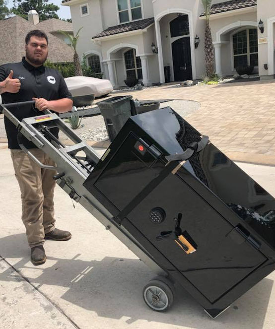 Nick of Time mover gives thumbs up while delivering gun safe
