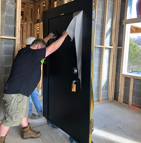 Nick of Time movers installing a vault door