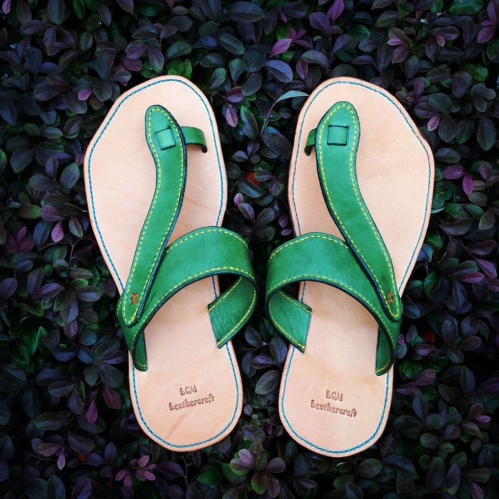 High angle view of finished handmade leather shoes on wooden surface