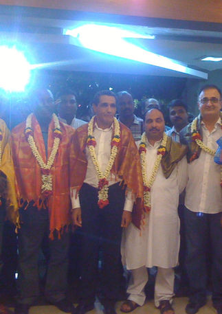 Group of men with garlands, diplomatic officials with Prof Kemak