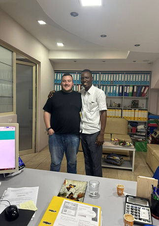 Two men smiling in an office
