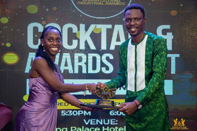 Woman presents award to man at ceremony