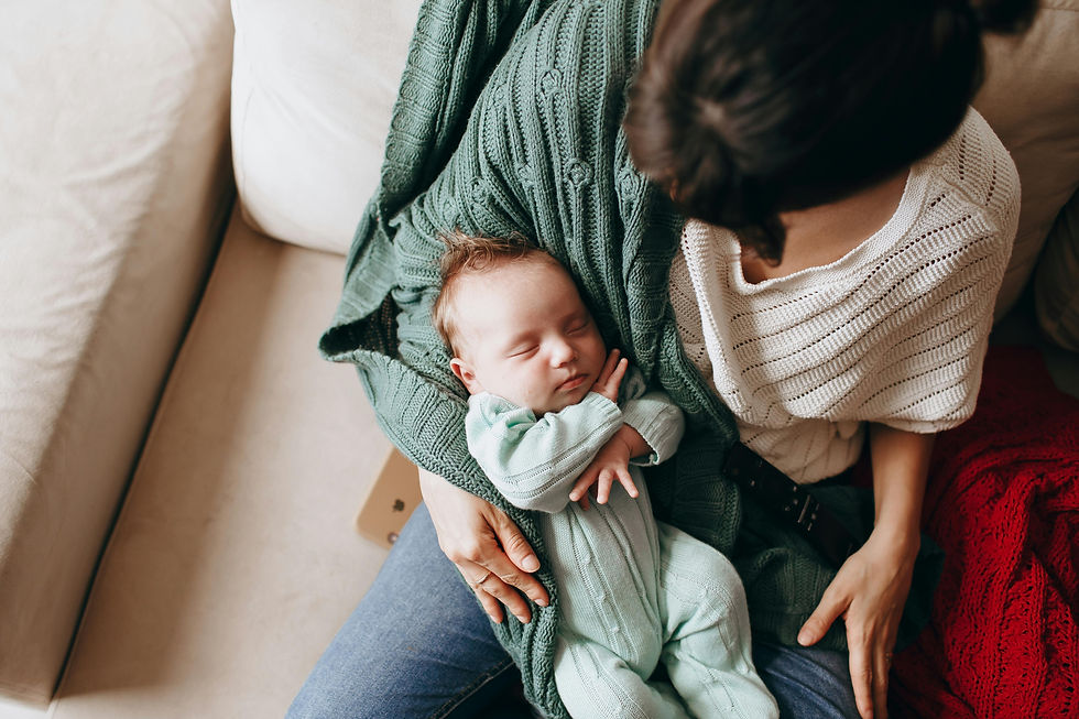 Mother gently holding her sleeping newborn baby — imitating the heartbeat calming technique