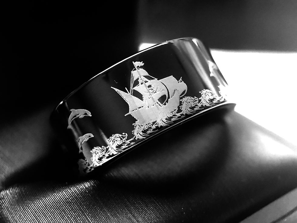 Thumbnail: Men’s black tungsten wedding band with intricate pirate ship and dolphin engraving.