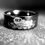 Thumbnail: Black tungsten ring with otters in river pattern engraving, unisex design, suitable as a wedding band, engagement ring