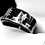 Black tungsten wedding band engraved with a hunting scene, featuring a hunter, dogs, and elks.