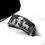 Thumbnail: Black tungsten wedding band engraved with a hunting scene, featuring a hunter, dogs, and elks.