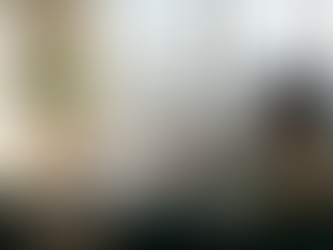 Man searches luxury rentals on sofa in sunlit apartment