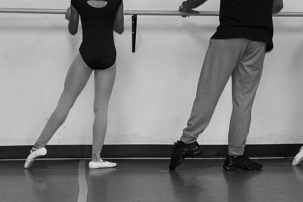 Eye-level view of a dancer practicing ballet in a bright studio