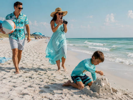 Family walking on Destin beach with sandcastle