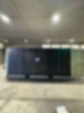 Shipping container tornado shelter in facility
