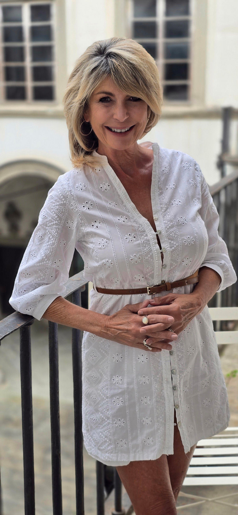 Photo of Jessica in a white dress outside.