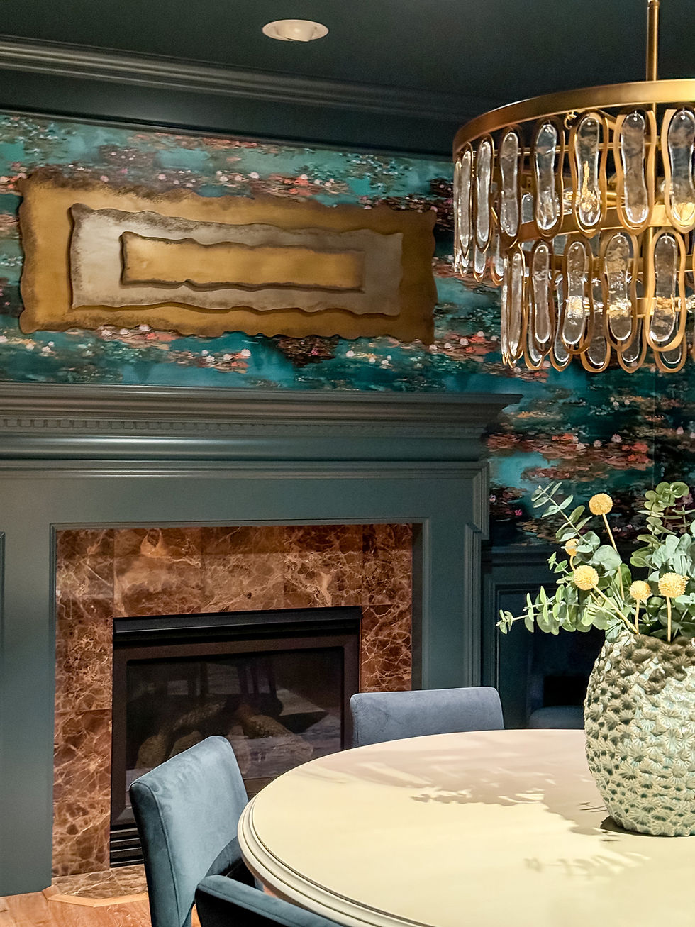Close up photo of dining room with green and pink wallpaper and fun chandelier.