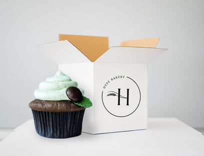 chocolate cupcake with mint frosting in front of Hype Bakery box