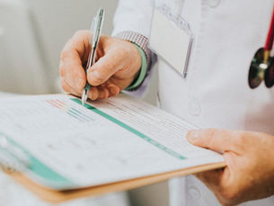 Online doctor's note Canada — licensed physician preparing same-day medical documentation