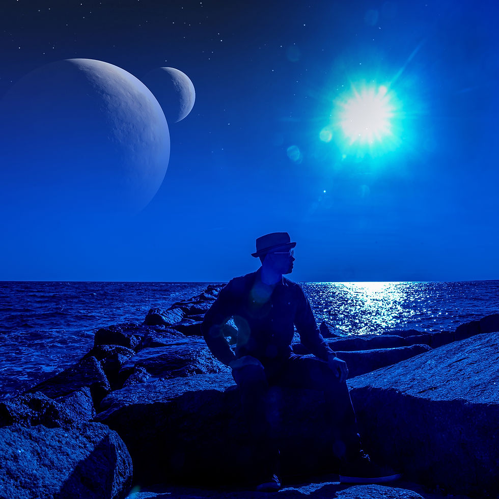 Silhouette of Ionne sitting on a rock jetty at night against the ocean horizon with a double-moon and bright star in the sky