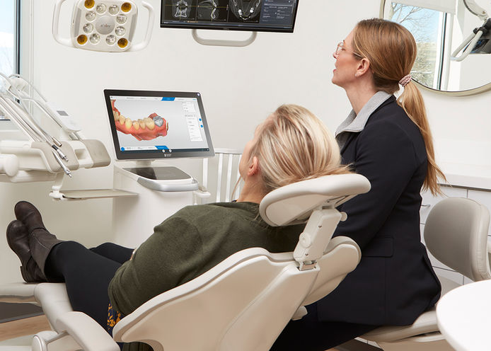 Lifestyle portrait photography of female dental practitioner with their patient taken in her high tech operatory for Henry Schein Dental
