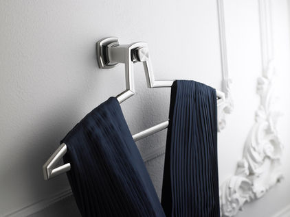 Elegant sleeveless navy dress on modern silver hanger displayed against a white framed wall