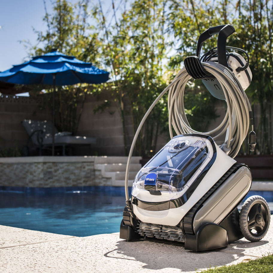 Polaris PCX 864 robotic pool cleaner with caddy beside pool